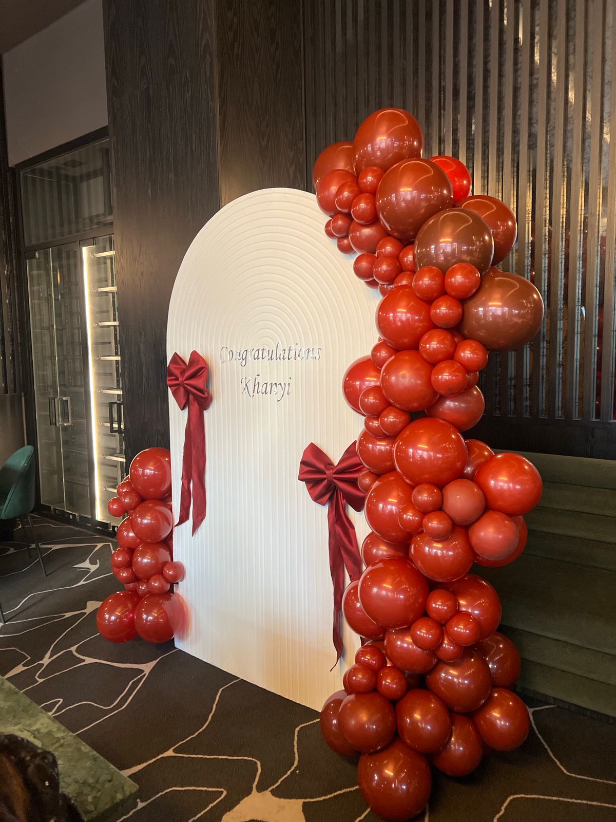 Red balloon garland installation