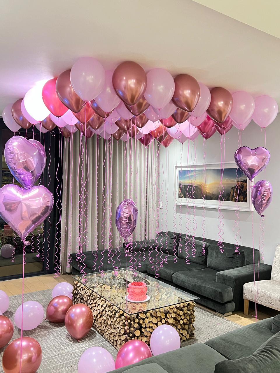 Pink ceiling balloons with purple heart foils