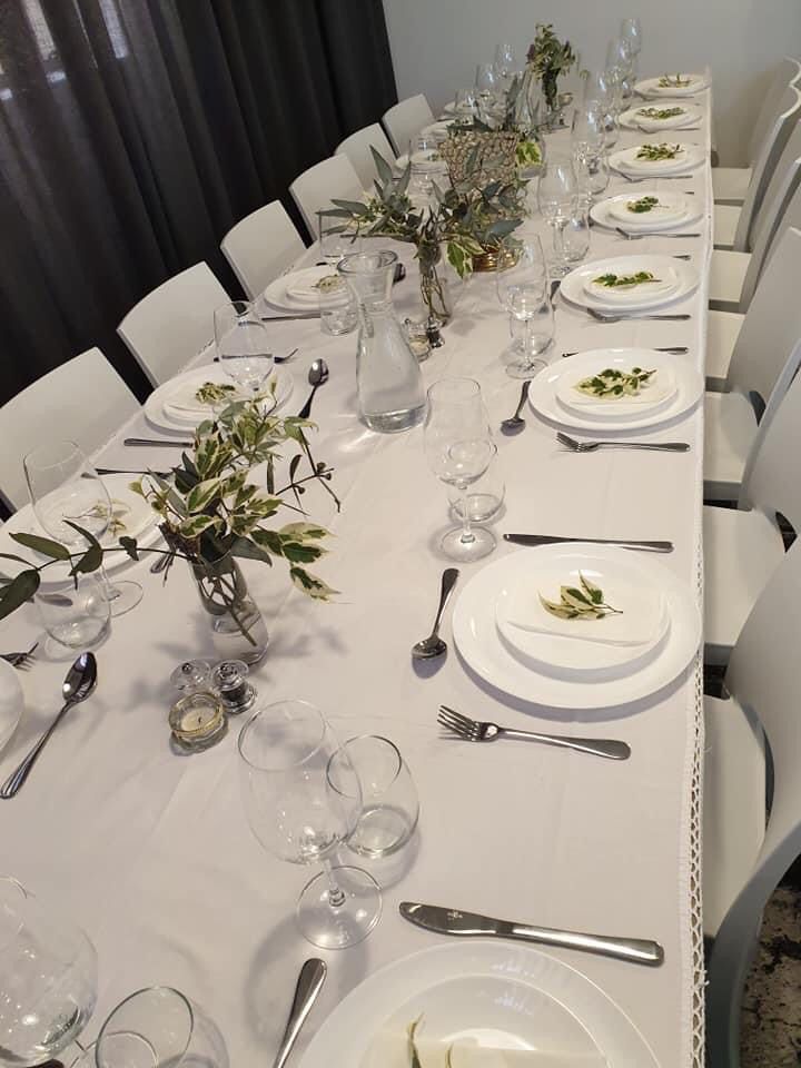 Elegant white table setting with greenery