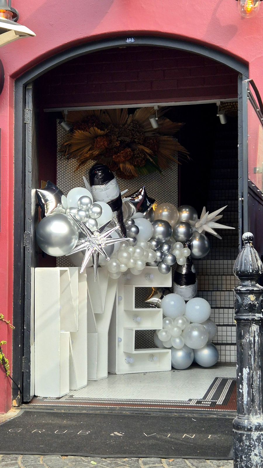Silver LOVE marquee letters with balloon garland